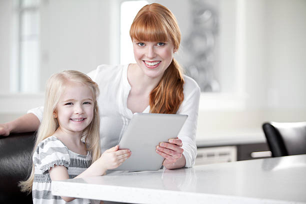 istock Mother and daughter holding a digital tablet 175576163