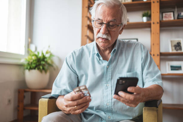 istock Senior man using mobile phone to check the instructions for a medicine 1755784626