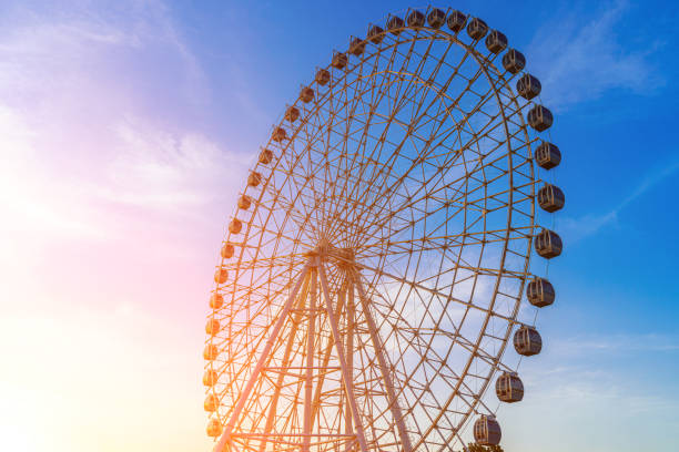 istock High ferris wheel at sunset or sunrise with cloudy sky background. 1755787372