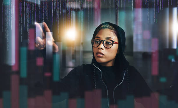 istock Woman, hacker and digital overlay at night in cybersecurity, programming or cryptocurrency at basement. Serious female person, employee or programmer working late on problem, cyber attack or malware 1755798046