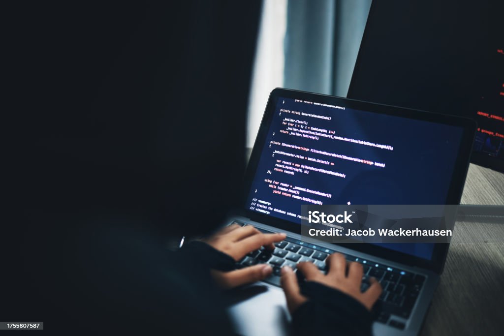 Person, hands and hacker on laptop at night in cybersecurity, coding malware or software at home. Hacking, working late and typing on computer in programming, algorithm or cyber attack in house 25-29 Years Stock Photo
