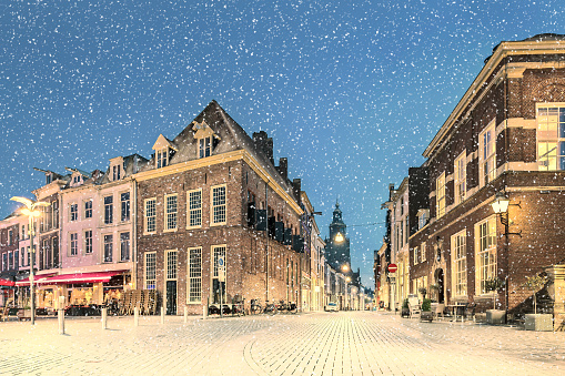 Dutch winter view with snowfall of the ancient city center of Zutphen, The Netherlands