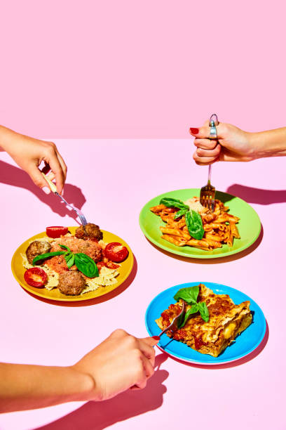 people holding forks over plates with different pasta dishes, lasagna,penne with bolognese sauce and farfalle with meatballs - plate food color image photography imagens e fotografias de stock