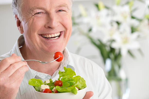 istock Happy mature man eating salad 175584515