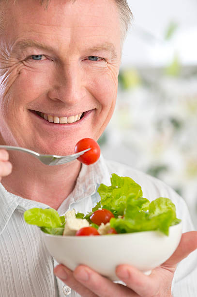 istock Happy mature man eating salad 175584638