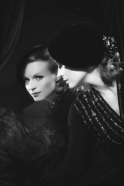 Black and white photograph of woman looking in the mirror Emulation of vintage style photography.Grain added for more film effect. femme fatale stock pictures, royalty-free photos & images