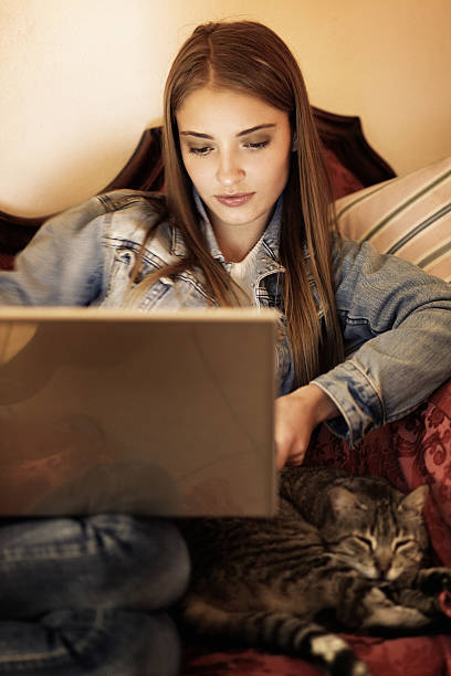 istock girl using laptop at home 175586259