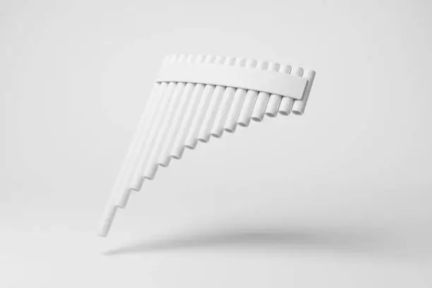 White pan flute (aka. panpipes) floating in mid air on white background in monochrome and minimalism. Illustration of the concept of musical instruments