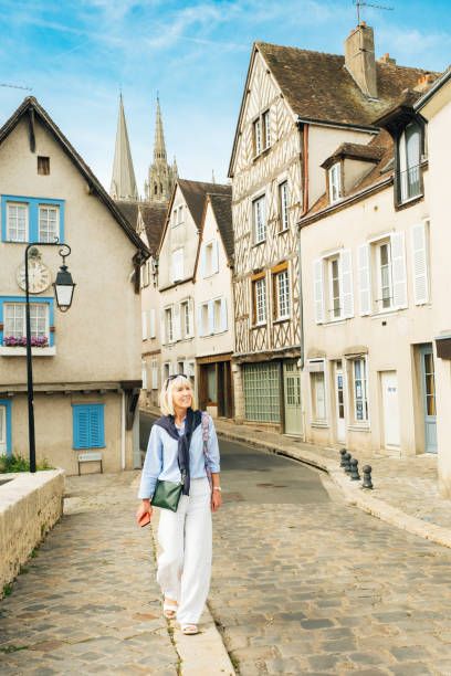 Chartres vacation, France Female tourist at Pont Bouju in the town of Chartres, south west of Paris, France. The twin spires of the cathedral are in the background. chartres cathedral stock pictures, royalty-free photos & images