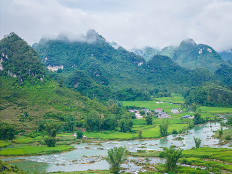 Aerial landscape in Quay Son river, Trung Khanh, Cao Bang, Vietnam with nature, green rice fields and rustic indigenous houses. Travel and landscape concept.