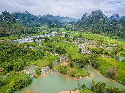 Aerial landscape in Quay Son river, Trung Khanh, Cao Bang, Vietnam with nature, green rice fields and rustic indigenous houses. Travel and landscape concept.