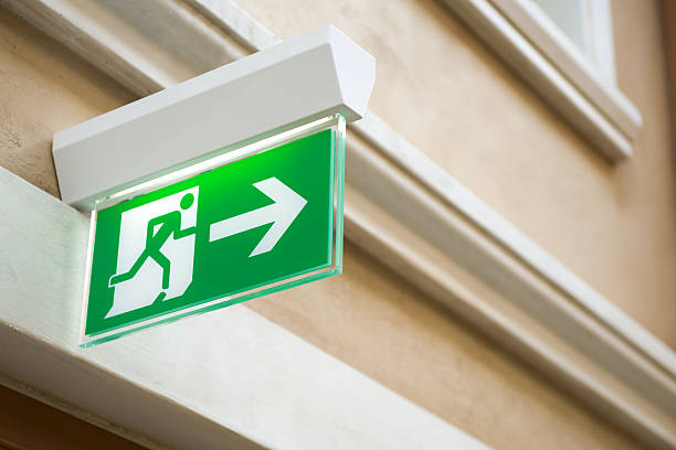 iluminação de sinais de saída de emergência - abstract arrow sign close up warning sign - fotografias e filmes do acervo