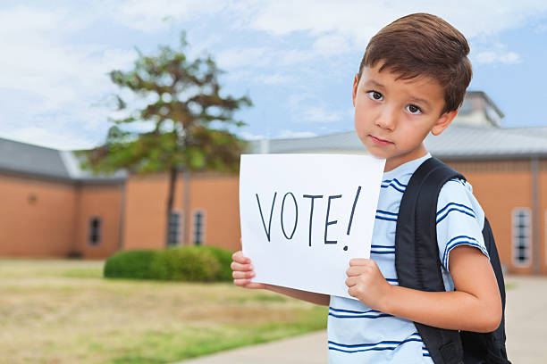 istock Sad young student at school holding a Vote Sign 175588214