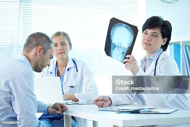 Examining Scull Xray Stock Photo - Download Image Now - 20-24 Years, 30-34 Years, 30-39 Years