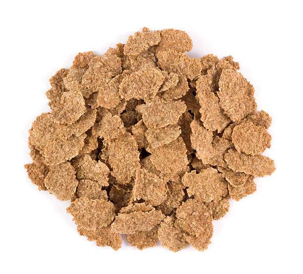 Bran flake heap Bran flake heap from above on a white background bran flakes stock pictures, royalty-free photos & images