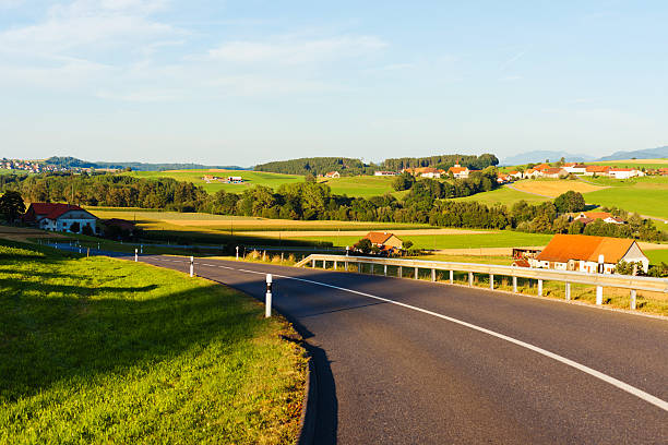 Country road and rural landscape in Jura Mountains, Swiss countryside.