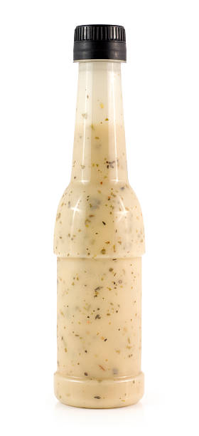 Bottle of salad dressing isolated on a white background Salad dressing on a white background. bottle of salad dressing stock pictures, royalty-free photos & images