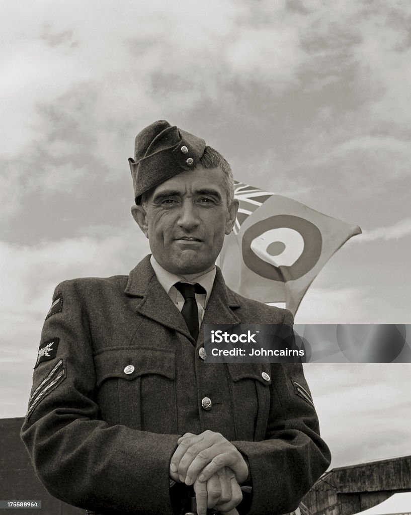 Battle of Britain. WW2 RAF ground crew member from Battle of Britain era with Union Jack and Airforce colours in background.Picture has been aged to give the feel of a vintage photograph. 1944 Stock Photo