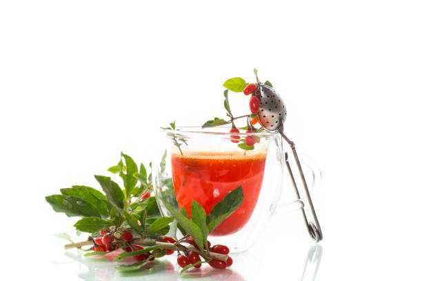 Prepared hot drink from ripe goji berries in a glass cup stock photo