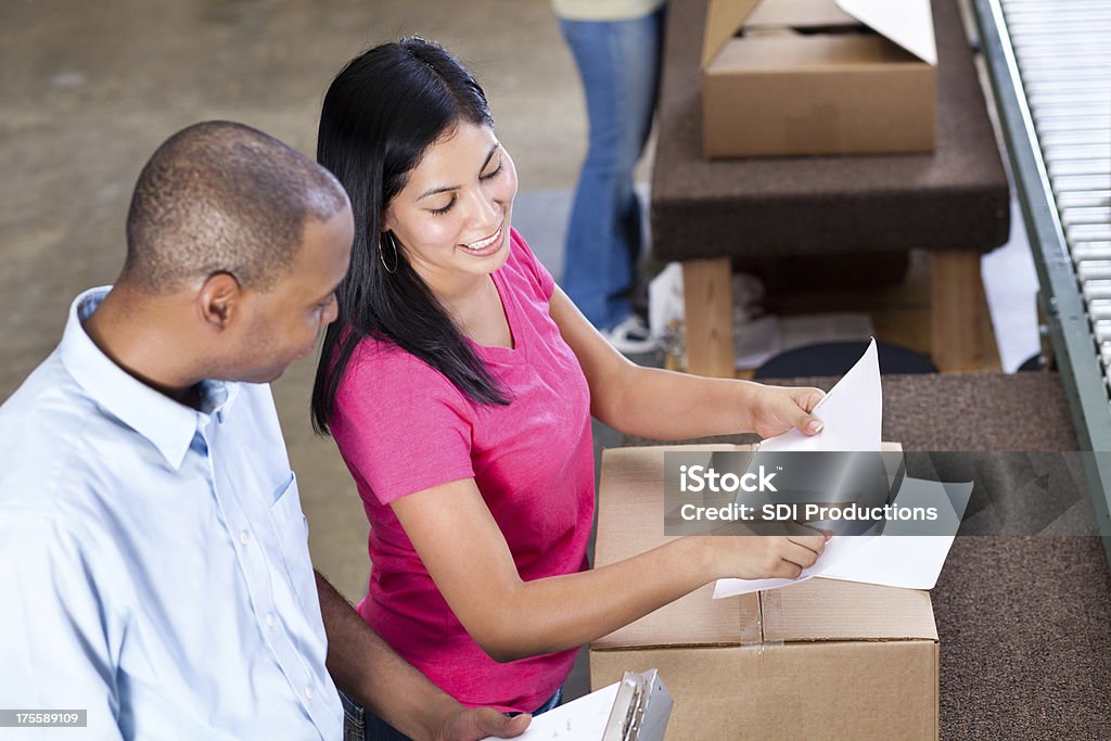 Lager Arbeiter über Dokumente an der Produktion - Lizenzfrei Auslieferungslager Stock-Foto