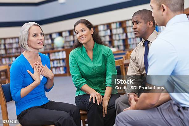 Diverse People Having Discussion In A Group Support Meeting Stock Photo - Download Image Now