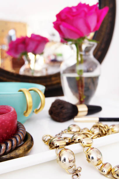 istock Vanity table with jewelry pieces and pink rose on vase 175589172