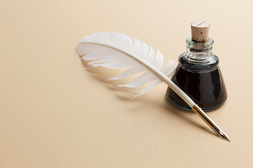 Quill pen and ink bottle background with copy space.