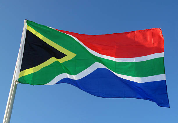 Flag of South Africa "South African flag billows in breeze, Hermanus, Western Cape province, South Africa" southern africa stock pictures, royalty-free photos & images