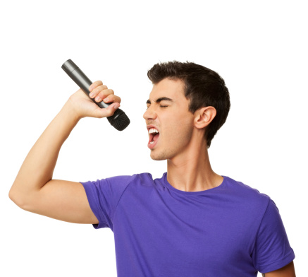 Young boy singing his heart out into a microphone. Horizontal shot. Isolated on white.