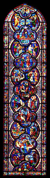 "Detail of the stained glass window St John the Divine of the cathedral Notre Dame, Chartres. This window is one of the row lower windows at the south aisle of the church.The window is made in the 13 th century"