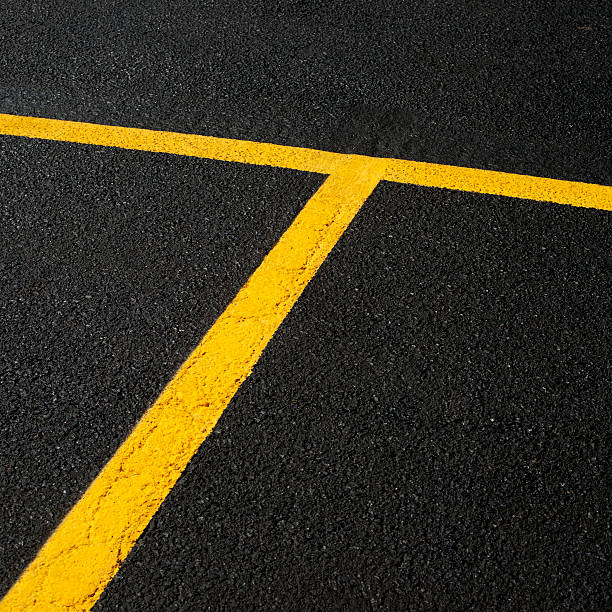 Fresh Painted Asphalt New Asphalt in a parking lot with freshly painted parking lines. freshly painted road markings stock pictures, royalty-free photos & images