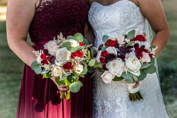 istock Bride with bridesmaid holding flower bouquets in their hands 1755909274
