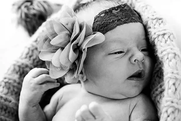 Cute baby girl with big flower.