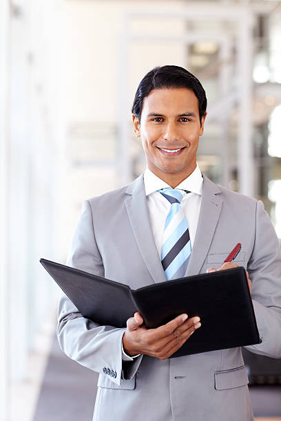 istock Male Business Executive Writing In a Folder 175591366