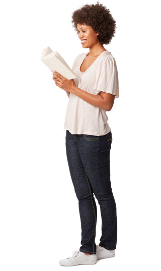 Full length of an African American woman in casual wear reading book. Vertical shot. Isolated on white.