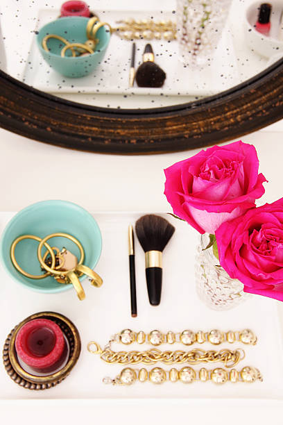 istock Vanity table with jewelry pieces and pink rose on vase 175591685