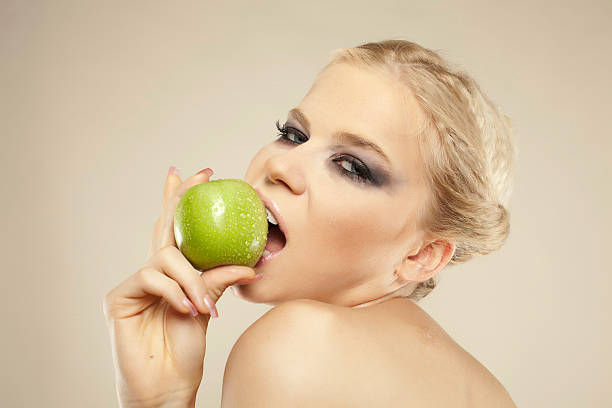istock Blonde woman eat green apple 175591949