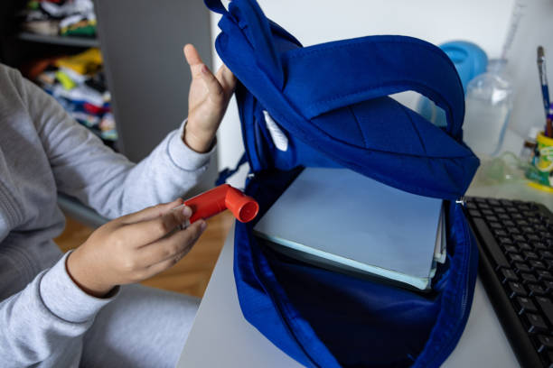 istock Unrecognizable Caucasian schoolboy packing his asthma inhaler into backpack 1755922690