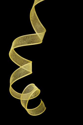 Gold ribbon design element isolated on black