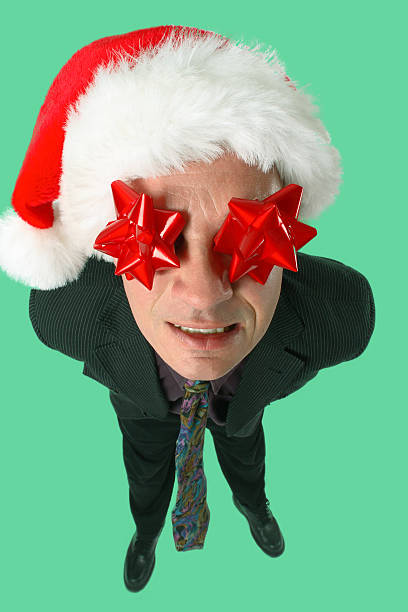 Life Of The Christmas Party "Man with bows on his eyes and a santa hat, got carried away at the office Christmas party." drunk visual stock pictures, royalty-free photos & images