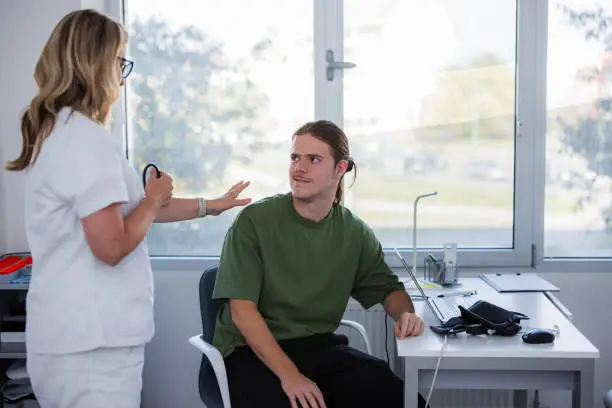 Photo of Male patient getting a piece of an advice from a doctor