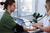 Young man having blood pressure measured