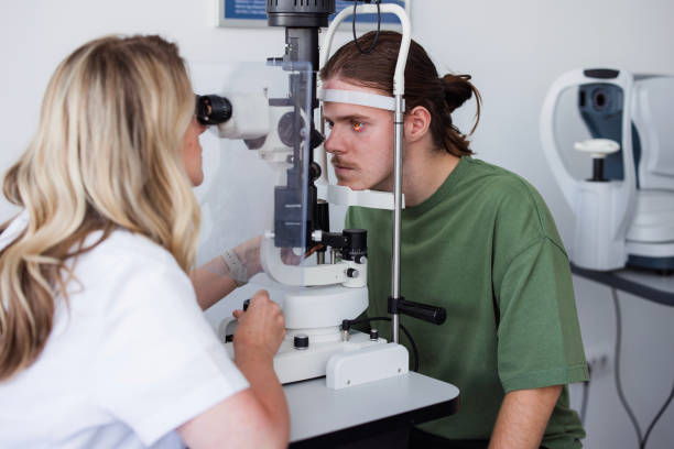 Ophthalmologist examining patient with slit lamp