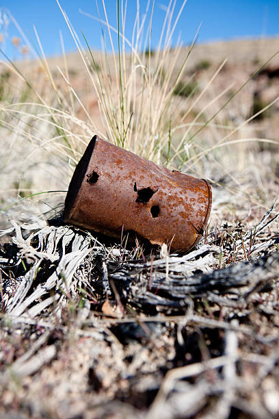 rusted can with bullet holes