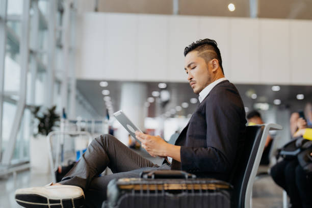 istock Businessman using digital tablet in the airport 1755941236