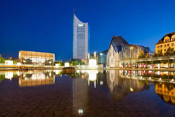 Gewandhaus concert hall with Mende fountain and the new university campus at Augustusplatz in Leipzig, Germany at night
