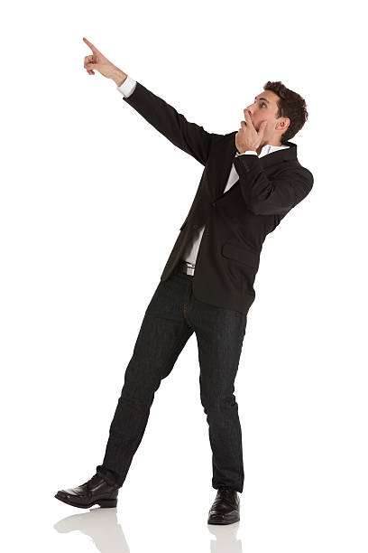 istock Surprised businessman pointing away with finger 175594655