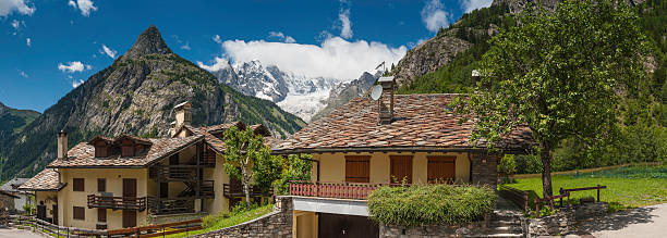 istock Picturesque Alpine chalets below mountain peaks panorama 175594737