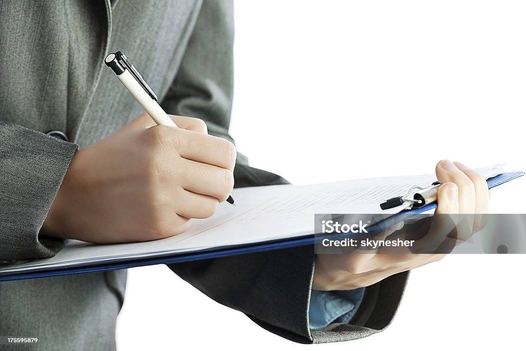 Businessperson signing a contract. Unrecognizable businessperson writing a report. Adult Stock Photo