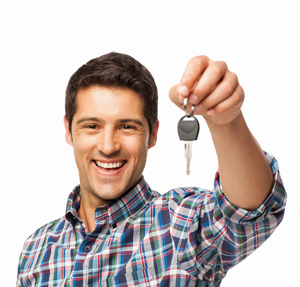 Portrait of a cheerful young man holding car key. Square. Isolated on white.